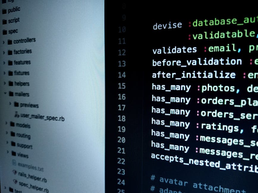 Close-up of a computer screen displaying lines of colorful HTML and CSS code on a dark background, with a person's blurred hand and finger interacting with the keyboard in the foreground. The scene is